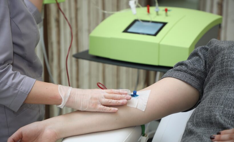 Healthcare provider administering ozone blood therapy IV treatment to a patient