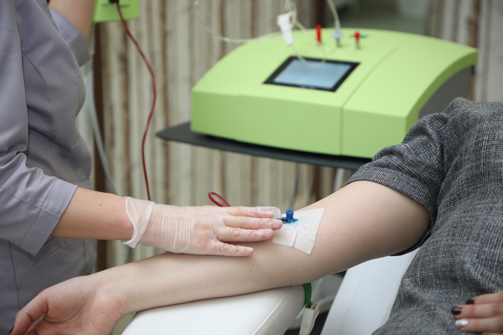 Healthcare provider administering ozone blood therapy IV treatment to a patient