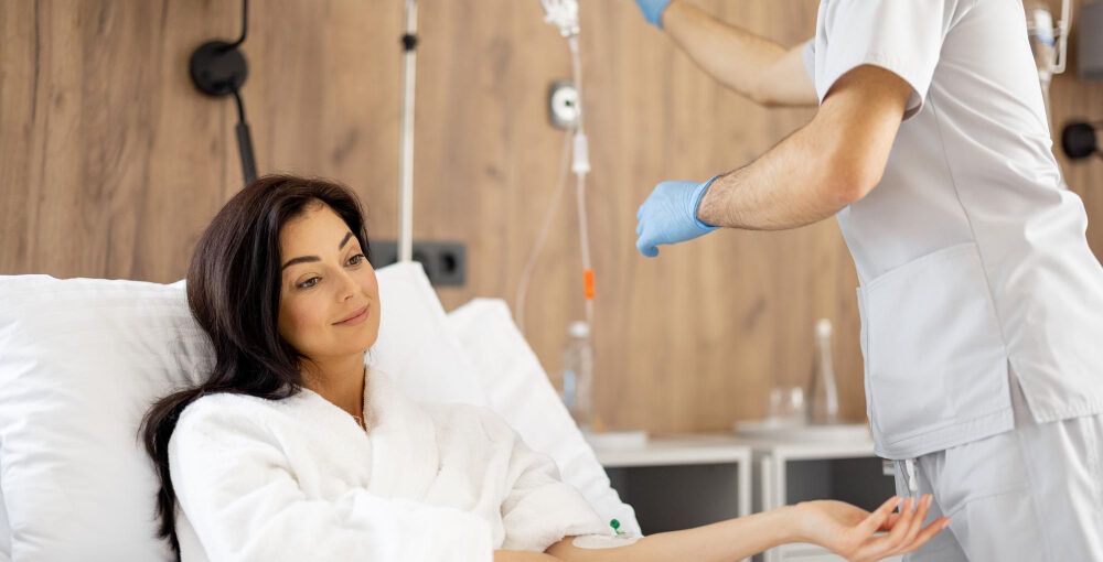 Relaxed patient receiving IV autohemotherapy as part of ozone therapy for inflammation in a wellness clinic room