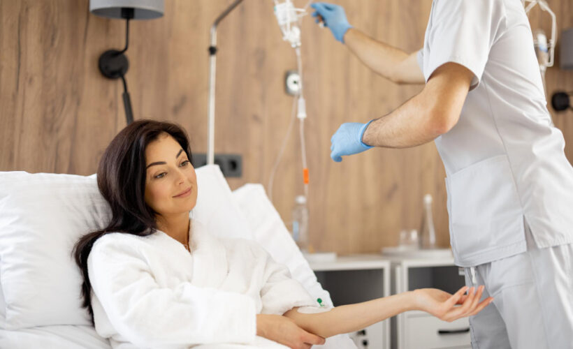 Relaxed patient receiving IV autohemotherapy as part of ozone therapy for inflammation in a wellness clinic room