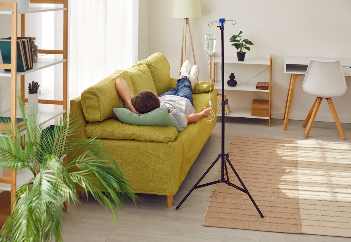 Person relaxing at home while receiving O3UV therapy for athletes