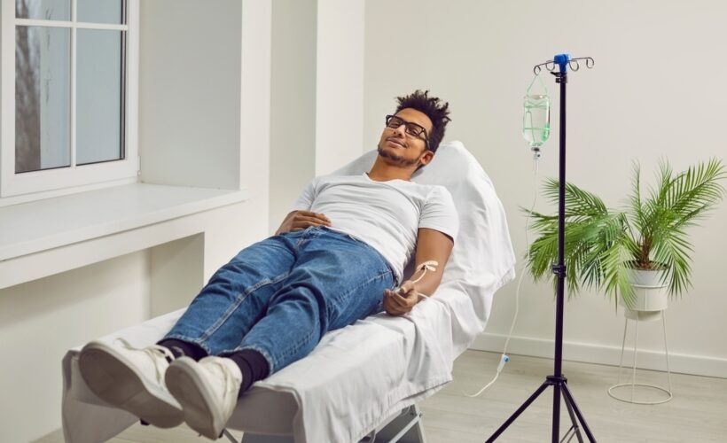Person relaxing in a treatment chair during ozone therapy for sports injuries