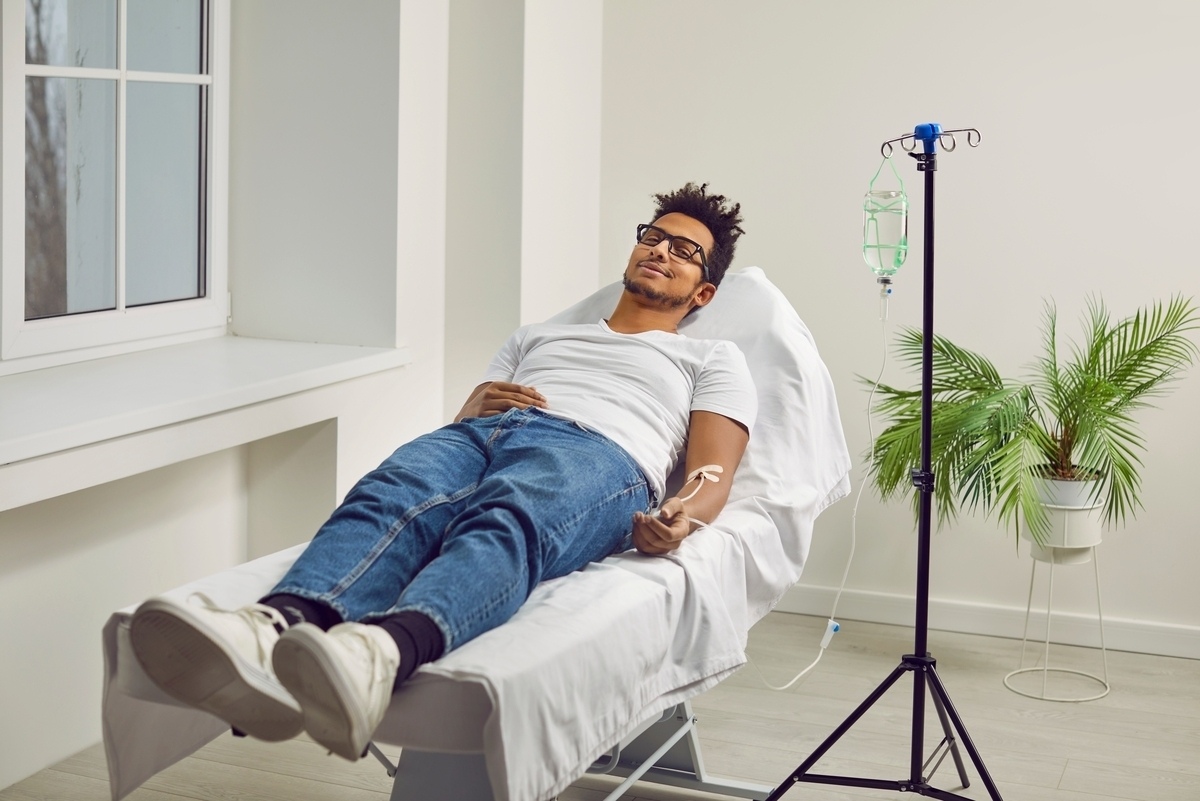 Person relaxing in a treatment chair during ozone therapy for sports injuries