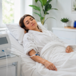 Woman in white robe resting peacefully with eyes closed during an IV session representing the relaxing effects of ozone therapy and sleep improvement